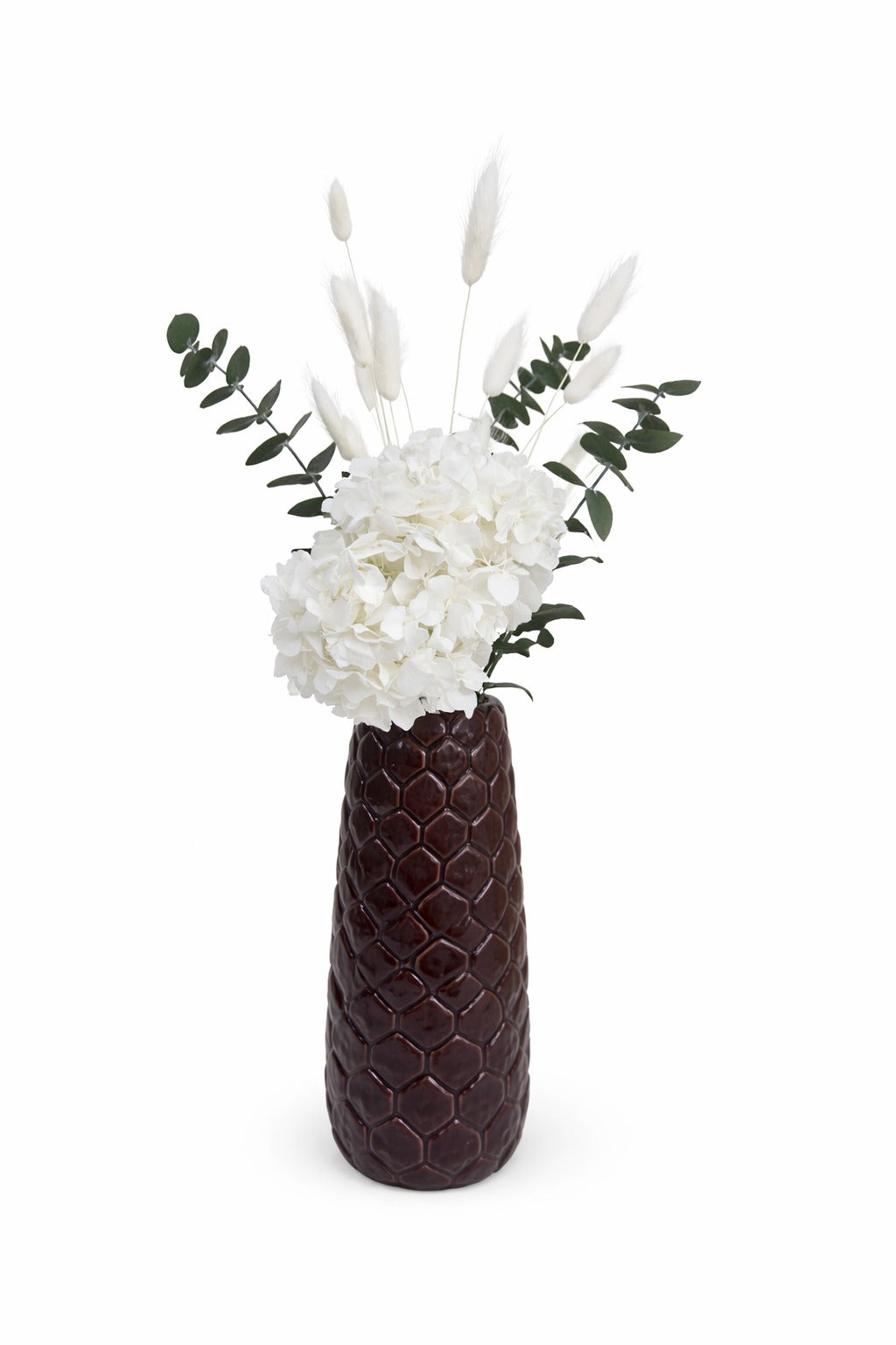 Hortensia blanca preservada con eucalipto y pampas en jarrón decorativo sobre fondo blanco